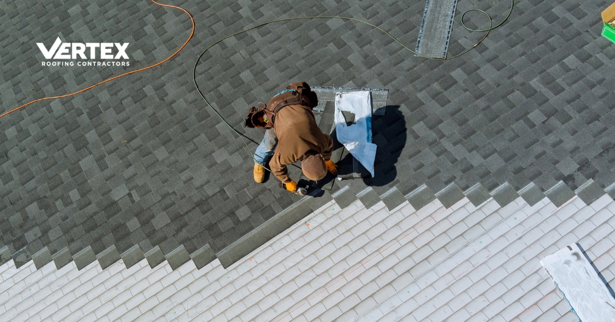 Aerial view of contractors replacing shingles on a suburban home roof Roof replacement project showing workers installing shingles